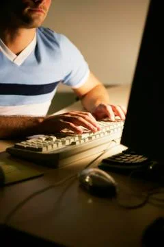 Man typing on computer keyboard Stock Photos