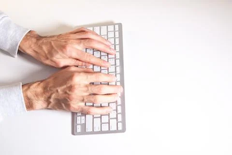 Man typing on a computer keyboard. Stock Photos