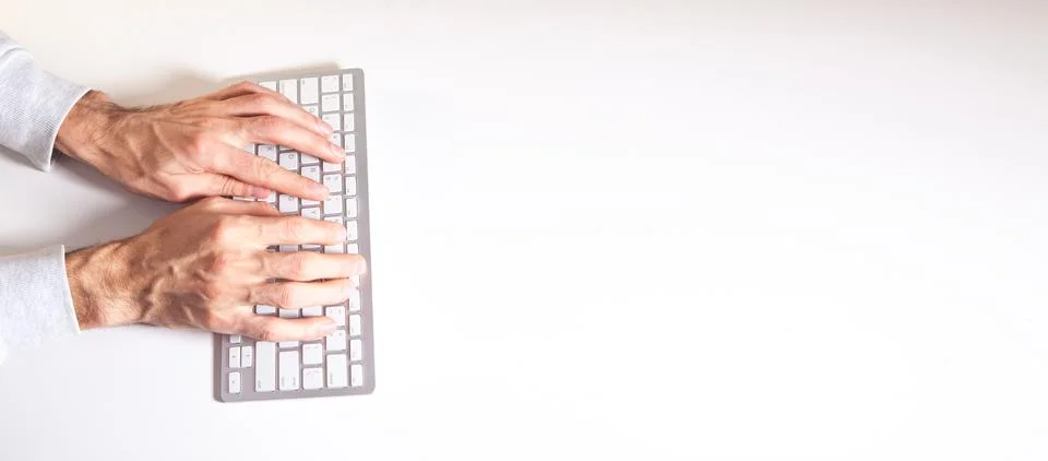 Man typing on a computer keyboard. Stock Photos