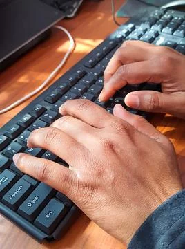 Man typing on computer keyboard from top angle at morning Stock-Fotos