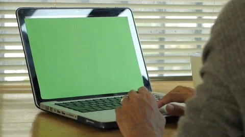 Man typing on computer laptop keyboard with green screen Stock Footage 56930537