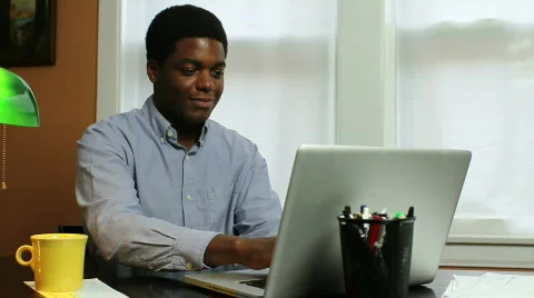 Man typing at computer, laughing Stock Footage