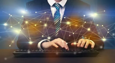 Man typing with connection graphics around Stock Photos