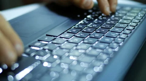 Man typing on dark laptop computer at night, beautiful cinematic soft focus shot Stock Footage 64217352