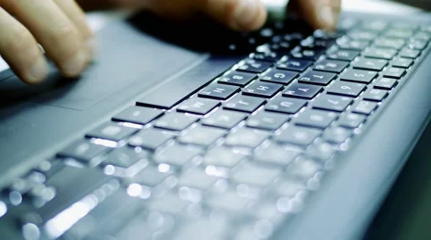 Man typing on dark laptop computer at night, beautiful cinematic soft focus shot Stock Footage 64217574