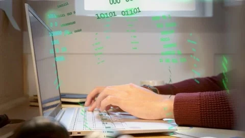 Man typing at desk generating green alphanumeric overlay in technology demo, Stock Footage 335739268