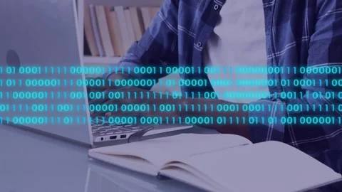 Man typing at desk, spawning cyan binary stream drifting across laptop and notes Stock Footage 334703566