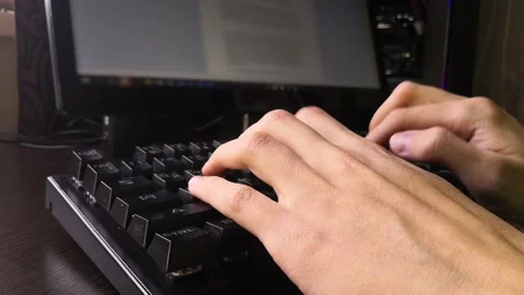 A man is typing documentation on a keyboard while sitting at a computer Stock Footage 160555827