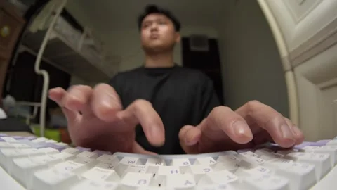 Man Typing Fast on Keyboard with POV Fisheye Lens View, Remote Worker Concept Stock Footage 334161428