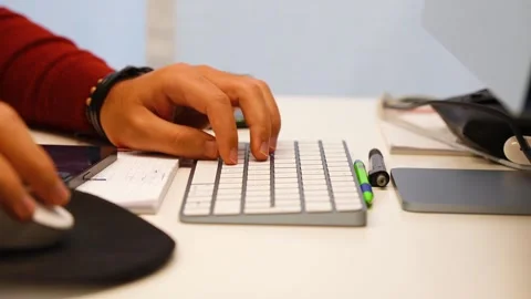 Man typing on his keyboard at computer Stock Footage 300414002