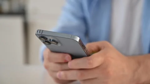 Man typing on his smartphone. Mobile testing,online services concept Stock Footage 254303038