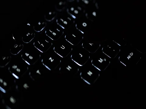 Man typing on illuminated keyboard 動画素材 69857362