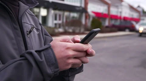 Man Typing on iPhone 6 Outside Shopping Plaza Video stock 46079215