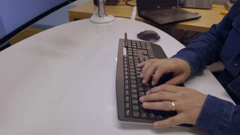 MAN TYPING A KEYBOARD IN HIS OFFICE Stock Footage 149844891