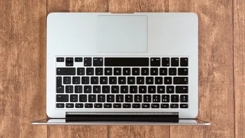 Man typing into keyboard of a laptop computer Stock Footage 131498785
