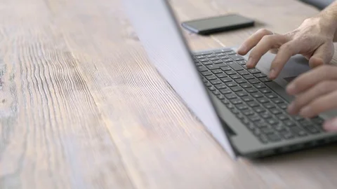 Man is typing on keyboard of laptop Stock Footage 126780286