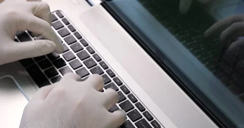 Man typing on a keyboard with protective gloves, top view Stock Footage 133918100