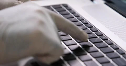 Man typing on a keyboard with protective gloves 動画素材 133918129