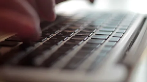 Man typing on a keyboard, shallow depth of field Stock Footage 50184454