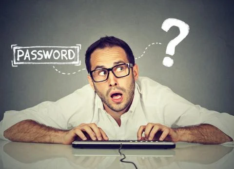 Man typing on the keyboard trying to log into his computer forgot password Stock Photos