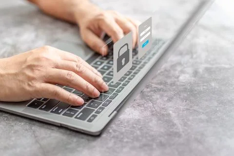 Man typing on keyboard to use computer network. Laptop screen showing login.. Stock Photos