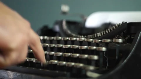 A man typing on the keys of an old typewriter 4K Stock Footage 146485181