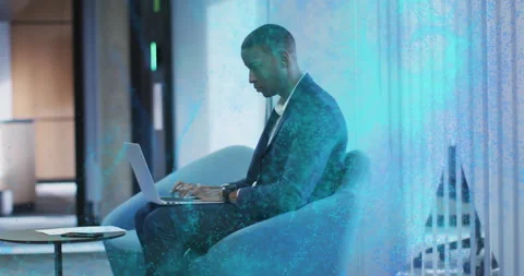 Man typing on laptop activating blue particles turning to camera engaging Stock Footage 314349146
