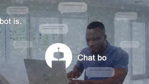 Man typing on laptop activating chat bubbles and robot icon while reading Stock Footage 332428625