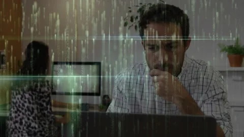 Man typing on laptop analyzing data starting code overlay in tech office for Stock Footage 319853252