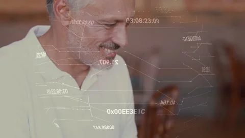Man typing on laptop, analyzing tech data, floating graphics above screen, Stock Footage 333485912
