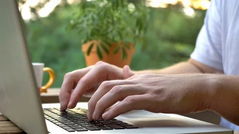 Man Typing on Laptop and Drinking Coffee Outside Video stock 93685990