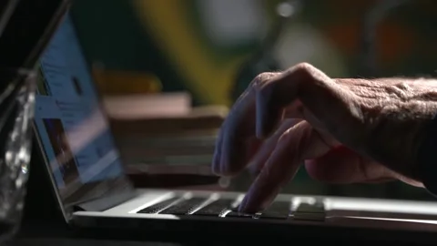 Man typing on a laptop and scrolling through, December, 15. 2023 Mumbai,India Stock Footage 258664370