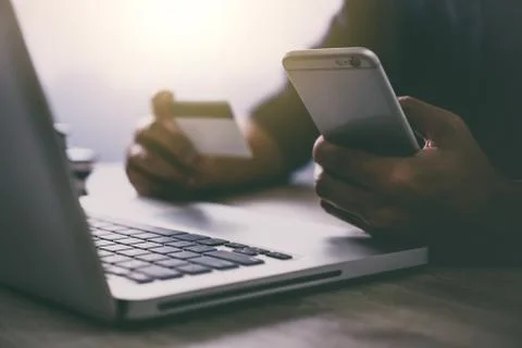 Man typing laptop and using smartphone for online shopping and pay by credit Stock Photos