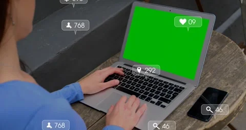 Man typing at laptop chroma screen, sparking social media icons orbiting hands, Stock Footage 328584647