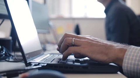 Man typing on a laptop closeup in slow motion Stock Footage 104428618