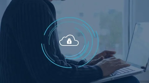 Man typing on laptop, cloud lock overlay fading over keys, blue rings pulsing, Stock Footage 335651721