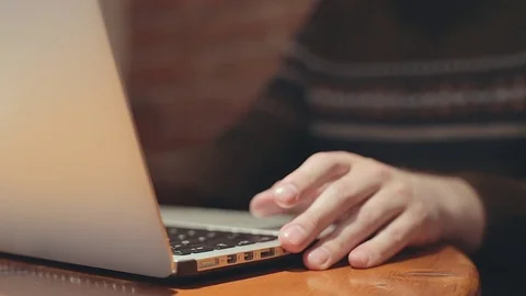 Man typing on laptop computer keyboard in cafe. FHD video shallow depth of field Stock Footage 76563530