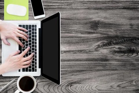 Man is typing on laptop computer. Top view, flat lay. Stock Photos