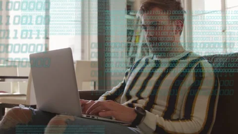 Man typing on laptop on couch, binary digits fading in overlaying torso, Stock Footage 333689593