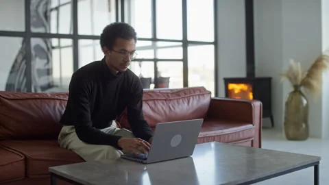 Man typing on laptop in a cozy modern office Stock Footage 292778331