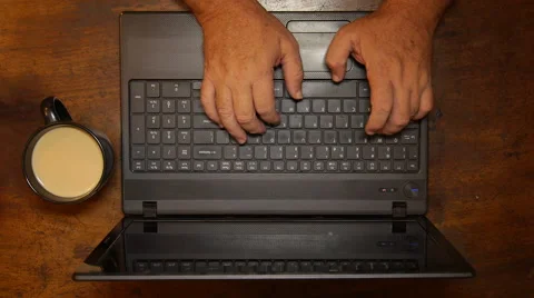 Man typing in laptop with cup of coffee - top view Stock Footage 57937216