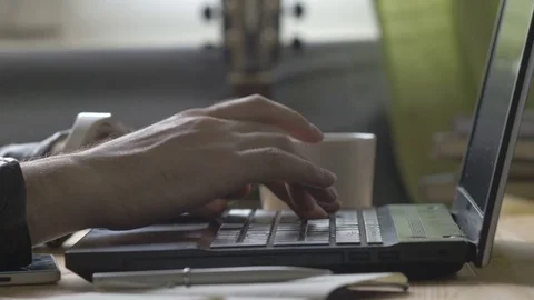 Man is typing on laptop with Cup of coffee Video stock 73967545