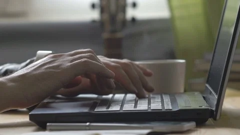 Man is typing on laptop with Cup of coffee Stock Footage 73968985