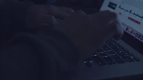 Man typing on a laptop in the dark. Stock Footage 84774450