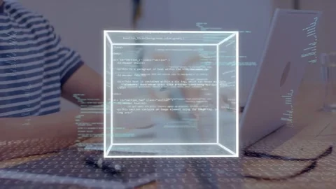 Man typing on laptop at desk, starting wireframe cube appearing growing rotating Stock Footage 335739162