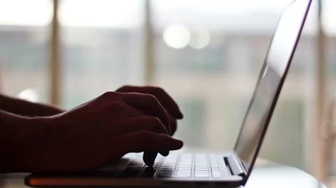 Man typing on a laptop at home Stock Footage 50184451