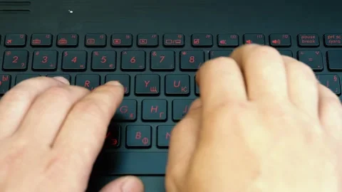 Man typing on a laptop keyboard. Close - up on the hands. Black keyboard. Video stock 130315458