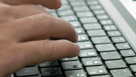 A man is typing on a laptop keyboard Stock Footage 70018775
