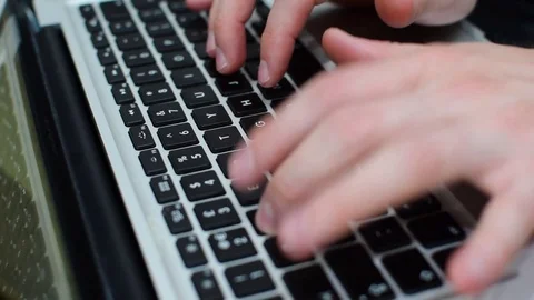 Man typing on a laptop keyboard 動画素材 79209764
