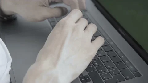Man typing on a laptop on the keyboard Stock Footage 136594440